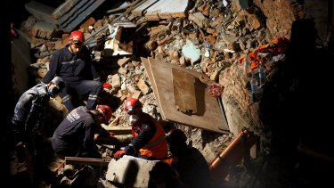 Rescue team members from Turkey, China and Nepal search through rubble in Kathmandu.