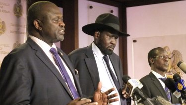 South Sudanese Vice-President Riek Machar, left, and President Salva Kiir, centre, call for calm at the presidential palace in Juba.