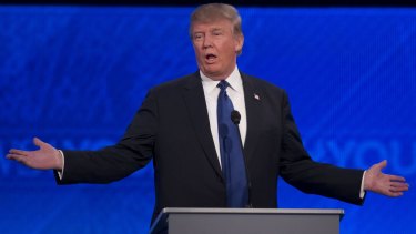 Proud outsider: Donald Trump is booed at the New Hampshire debate after attacking Jeb Bush.