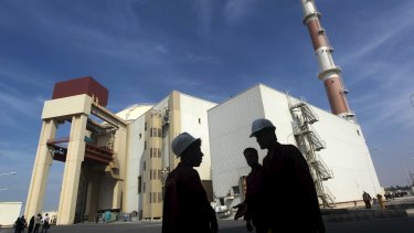 Iranian workers stand in front of the Bushehr nuclear power plant, about 1200 km south of Tehran.