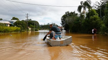 The new normal? Residents paddle down a street in Murwillumbah in March after heavy rains led to flash flooding.