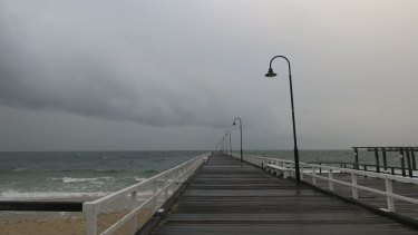 Storm clouds roll in over Port Phillip Bay off Kerferd Road Pier. 