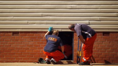 SES members search Leeton High School on Friday, which is now a crime scene.
