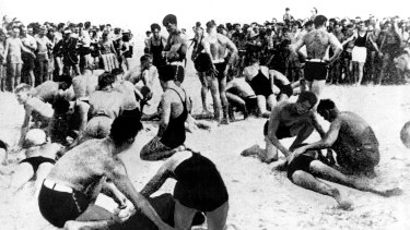 Exhausted bathers being revived by lifesavers on Bondi Beach on February 6, 1938. 