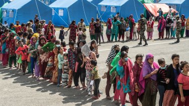 "So the last shall be first and the first last." Earthquake victims queue for aid in Nepal this year.