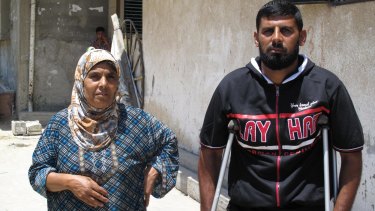 Basem Abu Jame, 31, with his sister. He is one of only three people who survived an airstrike on his house in Khan Younis on July 21 in which 26 people died. His leg is broken in three places. 