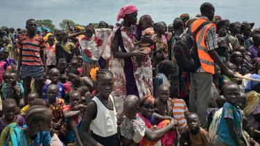 People in South Sudan line up to be registered with the UN World Food Program - some 23 million people were displaced by extreme weather events this past year.