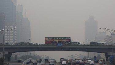 Pollution haze shrouds heavy traffic on the roads of Beijing on Tuesday. The Chinese capital city was hit by thick pollution although municipal transport authorities set up three car-free zones for World Car Free Day.