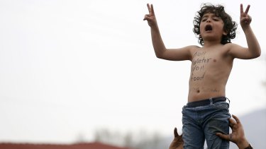 A child shouts a slogan during a protest demanding the opening of the border between Greece and Macedonia in the northern Greek border station of Idomeni on Monday. 