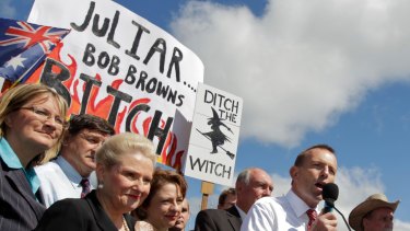 Tony Abbott in front of the infamous poster at the No Carbon Tax Rally outside Parliament House in 2011. 
