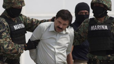 Guzman is escorted to a helicopter in handcuffs after being captured in Mexico City in February 2014. 