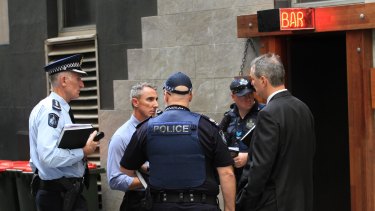 Police at the scene of the fatal shooting during filming in Brisbane's Eagle Street.