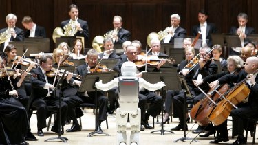 Mechanical maestro: a robot conducts an orchestra.
