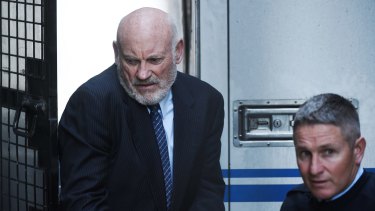 Ian Macdonald is led into the Supreme Court on Friday to be sentenced. 