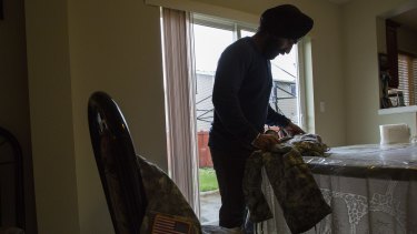 US Army Captain Simratpal Singh, who was recently granted a temporary religious accommodation that allows him to grow his beard and wrap his hair in a turban, at home in Auburn, Washington, this month.