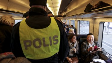 Swedish police check ID papers on a train travelling between Copenhagen in Denmark and Malmo in Sweden.