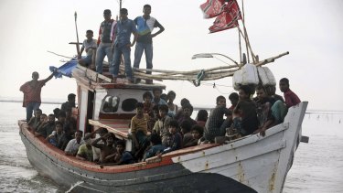 An Acehnese fishing boat full of rescued migrants approaches to dock in Simpang Tiga, Aceh province, Indonesia