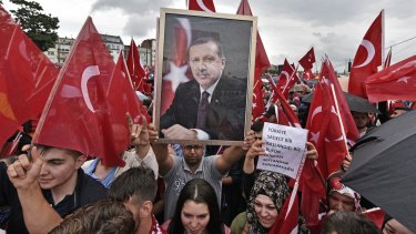 Supporters of the Turkish President march in a demonstration in Cologne, Germany. The crackdown in Turkey will test ties with Germany, Turkey's largest foreign investor.