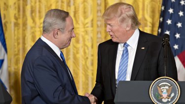 Trump, shaking hands with Israel's PM, says he is flexible with either a two-state or one-state solution in the Middle East.
