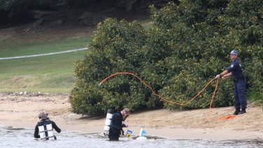 Police divers search the water around Cabarita Wharf, where the body of a woman was found.