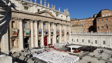 The tapestries of seven new saints hang from the facade of St Peter's Basilica during a Canonisation Mass by Pope Francis in St. Peter's Square on Sunday.