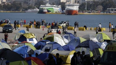 More than 5000 migrants are camped at the Athens port of Piraeus.