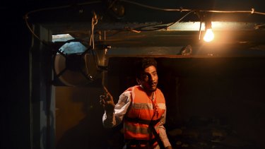 Mohamed, 25, of Pakistan, in the hull of the wooden fishing boat that he shared with the 52 people who died. 