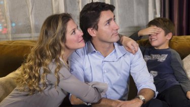 Xavier Trudeau, right, covers his eyes as his dad, Liberal leader Justin Trudeau watches the election results with his wife Sophie Gregoire on Monday.