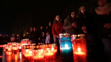 Bosnian Croat people, gather to light candles and pray for Slobodan Praljak, in southern Bosnian town of Mostar south of Sarajevo, on Wednesday.