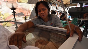 Seven-month pregnant Ruth-Jane Sombrio mourns over her husband Rogie Sebastian's body. The Shabu user was killed by police at home last month.