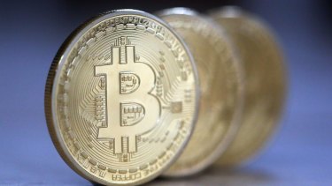 A review recommends the definition of e-currency be broadened to include digital currencies such as bitcoin that are not backed by a physical asset.