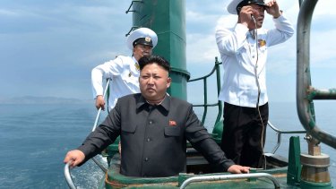 Lost from view: Kim Jong-un inspects a submarine in June.