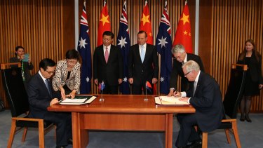 Chinese President Xi Jinping and then prime minister Tony Abbott witness the signing of the declaration of intent on the Australia/China Free Trade Agreement at Parliament House in Canberra.