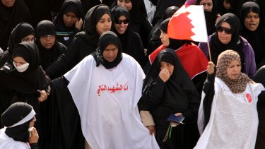 Bahraini women - one wearing a burial shroud emblazoned with the words "I am the next martyr" - march in protest in Manama, Bahrain, in March 2011.