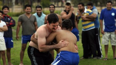 Fight club: The Age's Stathi Paxinos (left) gets to grips with a local Kabaddi expert.