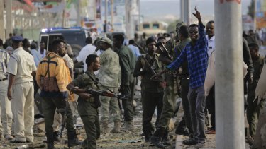 Security forces gather at the scene following a suicide car bomb attack in Mogadishu on Sunday.