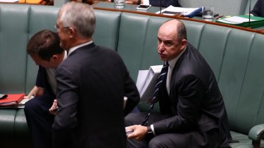 Prime Minister Malcolm Turnbull passes minister Stuart Robert at the end of question time on Monday.