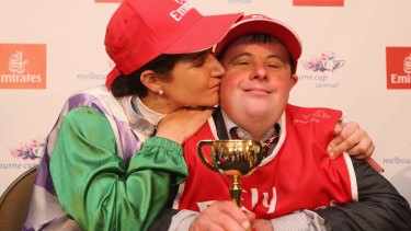 Michelle Payne celebrates her winning ride with brother and strapper Steven Payne.