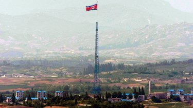 A giant North Korean flag flutters on the top of a tower in North Korea seen from the Demilitarised Zone near the border village of Panmunjom.