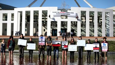 Protesters on the forecourt of Parliament House in Canberra on Thursday.