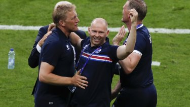 Iceland coach Heimir Hallgrimsson, left, celebrates with staff after the win. 