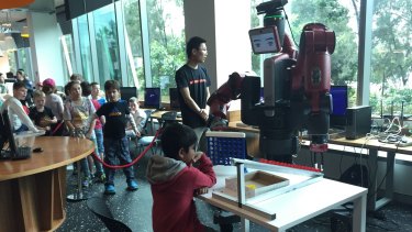 Eight-year-old Abhishek plays Connect Four with a robot named Baxter.  