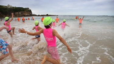 Coogee Nippers take to the water at the north end.