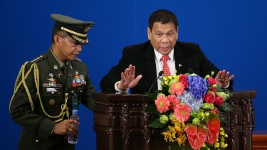 Philippines President Rodrigo Duterte, right, makes a speech during the Philippines-China Trade and Investment Fourm at the Great Hall of the People in Beijing on Thursday.