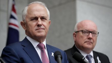Prime Minister Malcolm Turnbull and Attorney-General George Brandis announce the new laws on Tuesday.