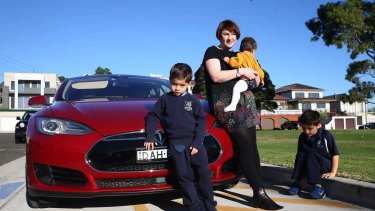 "I feel less guilty about driving": Belinda Sundaraj with her children and the family's electric car.