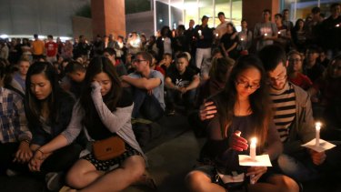 Student mourners console each other during a candlelight vigil at the University of Nevada Las Vegas for victims of the mass shooting.