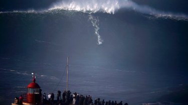 Surfers Tackle Giant Waves In Portugal