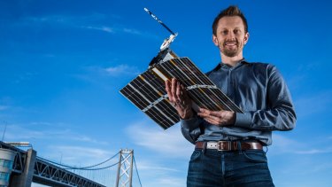 Australian physicist Chris Boshuizen with one of his small satellites. 