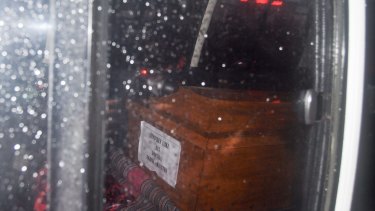 A coffin of one of the executed prisoners can be seen through the ambulance window transporting the bodies from Nusakambangan.